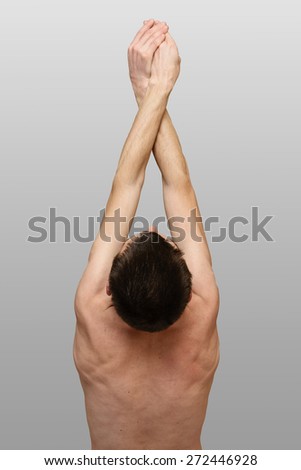 Backside view of skinny man with arms up