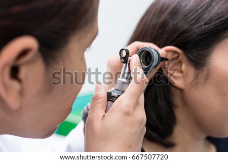 Doctor examined the patient\'s ear with Otoscope. Patient seem to have problems with hearing.