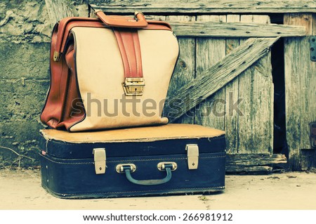 Old retro suitcases on wooden grunge a background. Old suitcases.