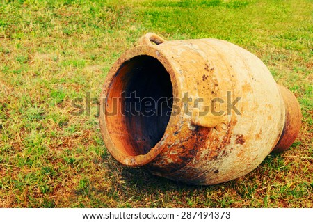 Greek clay amphora on a green grass
