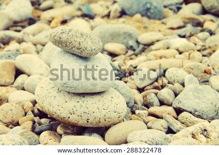Background from sea stones for design. Pyramid from sea stones. Sea stones