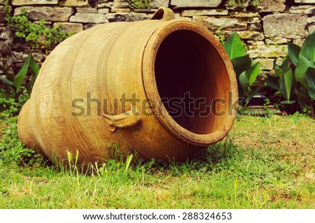 Greek clay amphora on a green grass
