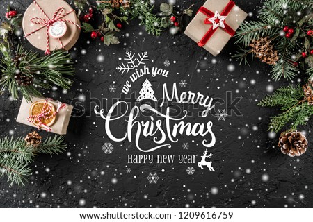 Christmas and New Year Typographical on holiday background with Fir branches, gifts, berries. Xmas and Happy New Year theme, snow. Flat lay, top view