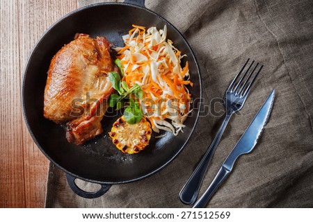 Tasty Baked chicken leg and vegetables on a pan