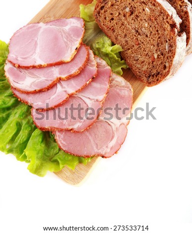 Pork ham slices with lettuce, rye bread and cheese isolated on white background