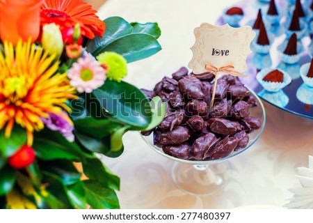 Dessert for holiday. Zephyr in chocolate, dark chocolate truffles sprinkled with cocoa, sweetness and flowers. Wedding dessert.