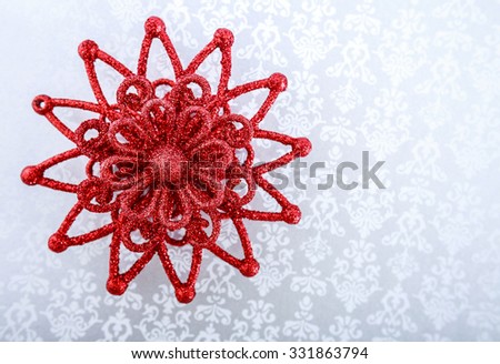 Red Christmas star on bright holiday background. Merry Christmas and New Year card. Winter holidays