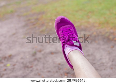 Vacation holidays. Woman right foot with purple shoes of girl relaxing, selective focus