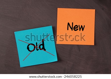 New instead of old concept sticky notes pasted on blackboard.