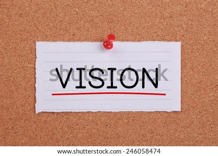 Vision concept note paper pinned on cork board.