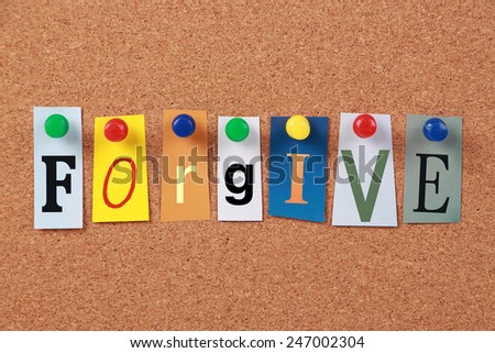 The word Forgive in cut out magazine letters pinned to a cork board.