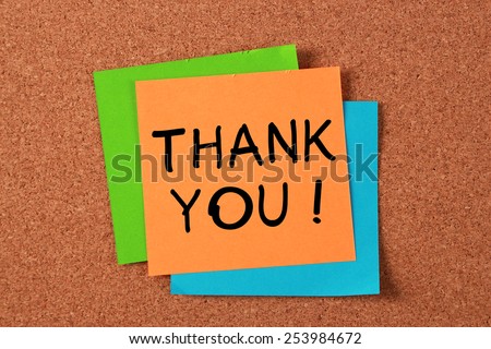 \'Thank You!\' post-it note pasted on cork board.
