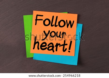 \'Follow your heart\' notes pasted on blackboard.