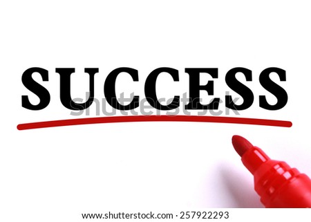 Success text is on white paper with red underline which is written by the red marker.