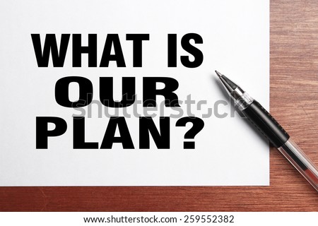 What is our plan text is on white paper with black pen aside.