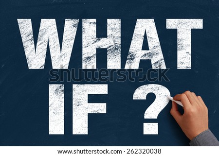 Businessman is writing What if text on blue chalkboard.