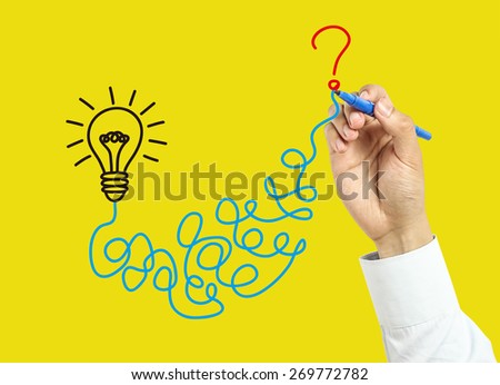 Businessman is drawing solution concept with marker on transparent board with yellow background.