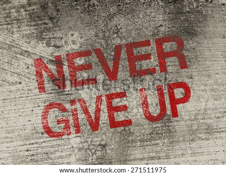 Never give up concept text is painted on old fashion wall.