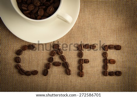 A cup of coffee beans with the word 