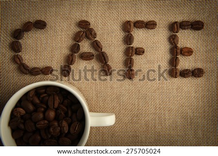 A cup of coffee beans with the word \