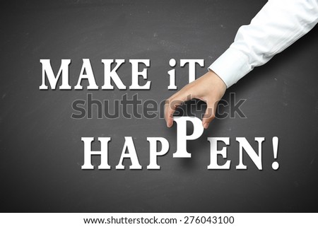 Make it happen concept with businessman hand holding against blackboard background.