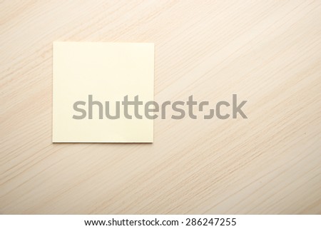 Blank sticky note is on the table as the background.