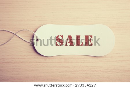 Sale label is on the wooden textured background.