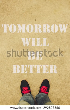 Tomorrow will be better text is painted on the ground in front of the feet.