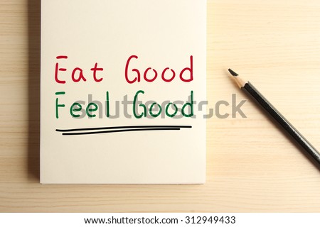 Text Eat good Feel good with underline on the notebook with a pencil aside.