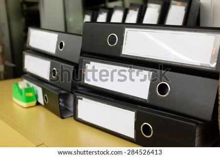 Stack of papers and folder in office