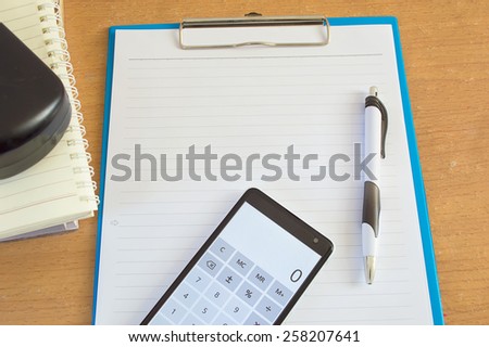 paper pen and calculator on the desk office