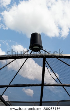 Closeup satellite dishes communication technology network with sky and cloud in background