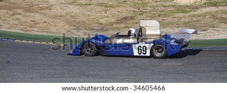 A classic sport racing car at a circuit corner
