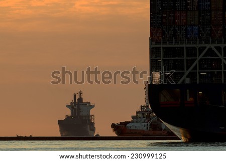 Birzebbuga, Malta November 15, 2014: As the sun rises, the shipping activities around Malta Freeport is evident, with tugboats getting ready for incoming movements.