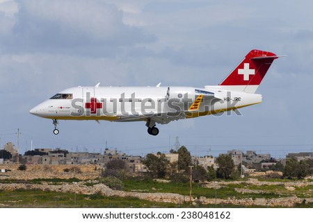 Luqa, Malta February 17, 2005: REGA - Swiss Air Ambulance Bombardier Challenger 604 (CL-600-2B16) landing runway 32.