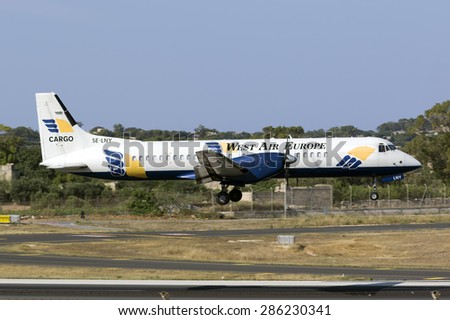 Luqa, Malta June 11, 2015: West Air Sweden Cargo British Aerospace ATP(F) landing runway 31, painted in white instead of the usual silver.