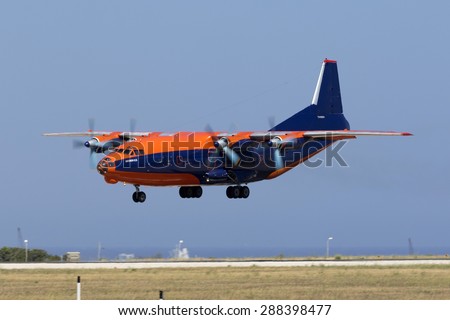 Luqa, Malta June 18, 2015: Cavok Air Antonov An-12BK coming in very low on runway 31 on a very windy afternoon.