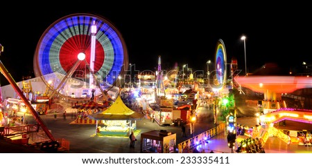 Carnival rides in action at night.