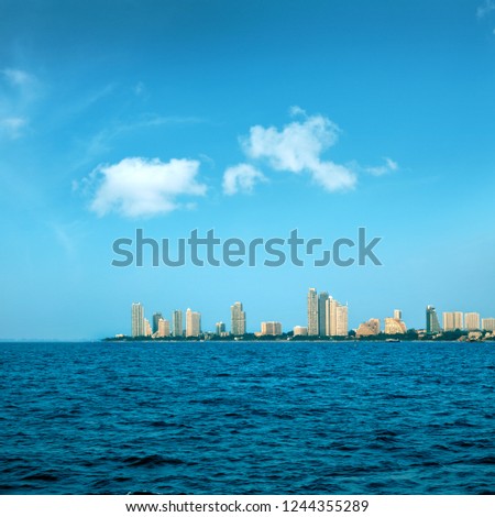 cityscape of modern architecture buildings with blue sea water over blue clear sky in downtown Pattaya, Thailand