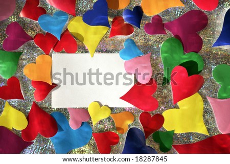 colorful paper hearts and empty note card