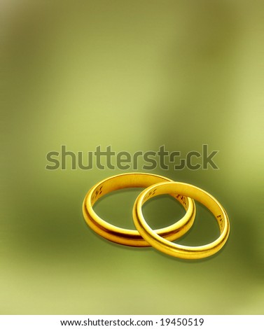 stock photo wedding rings over green background