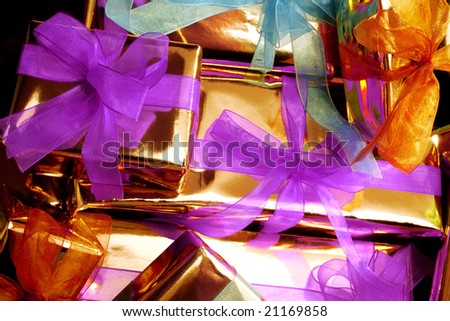 background image of golden color gift-box with colorful ribbons