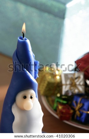 Santa Clause candle with gift boxes at Christmas time