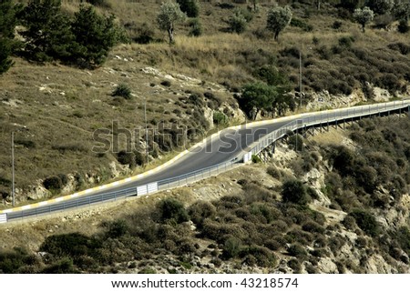 an image of a road curve among forest