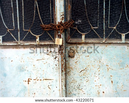an image of ruinous house and rusty lock