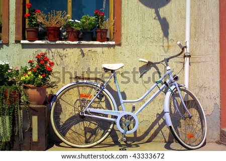 an image of parked bicycle front of window