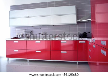 close up shot of a red modern kitchen with cabinet and drawers