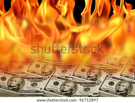 an image of a pile of dollar bills on fire