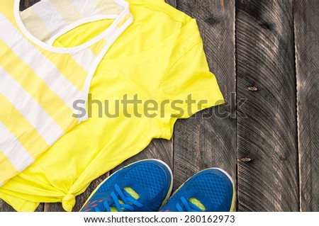 Running equipment for the woman on the old wooden background. Sport equipment