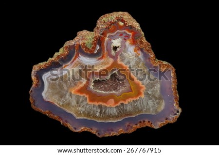 A cross section of agate stone with geode on a black background.  Origin:  Morocco, Asni